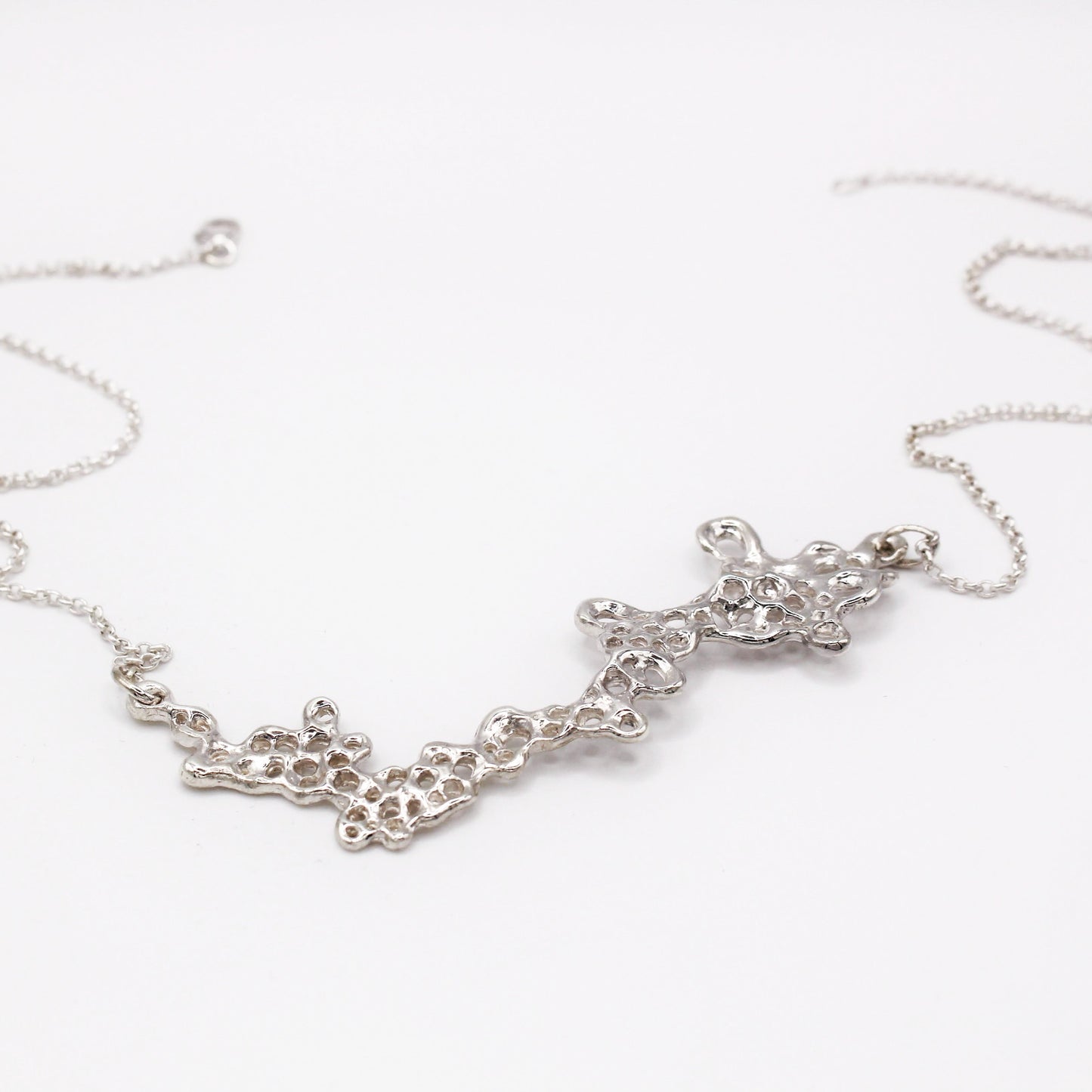 Raíz statement necklace handcrafted in sterling silver 925. Mediterranean-inspired jewelry featuring a large ocean-inspired pendant with sculptural, organic forms. A bold yet elegant sustainable piece, crafted for nature and contemporary jewelry lovers by Naturalesa.