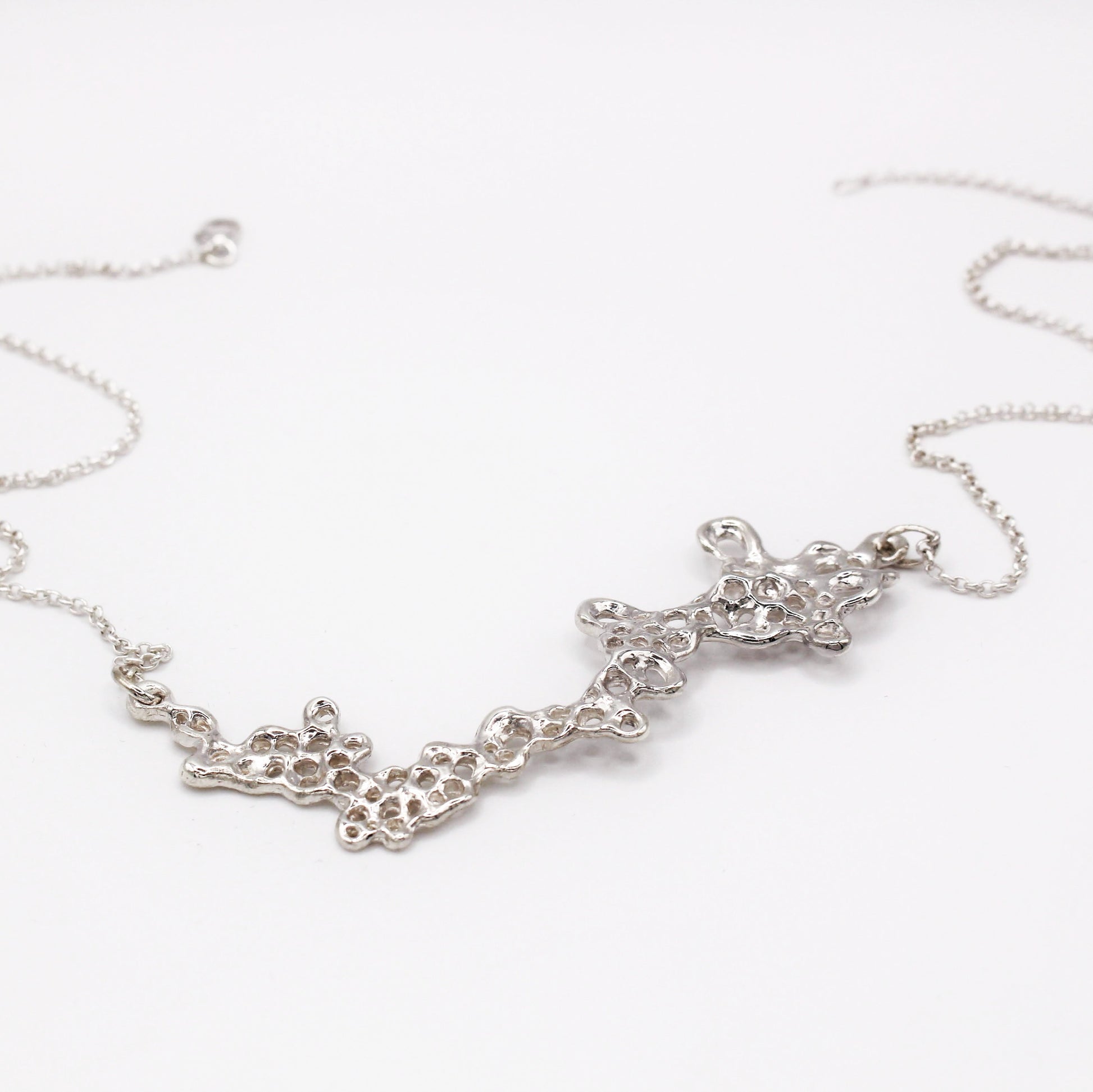 Raíz statement necklace handcrafted in sterling silver 925. Mediterranean-inspired jewelry featuring a large ocean-inspired pendant with sculptural, organic forms. A bold yet elegant sustainable piece, crafted for nature and contemporary jewelry lovers by Naturalesa.