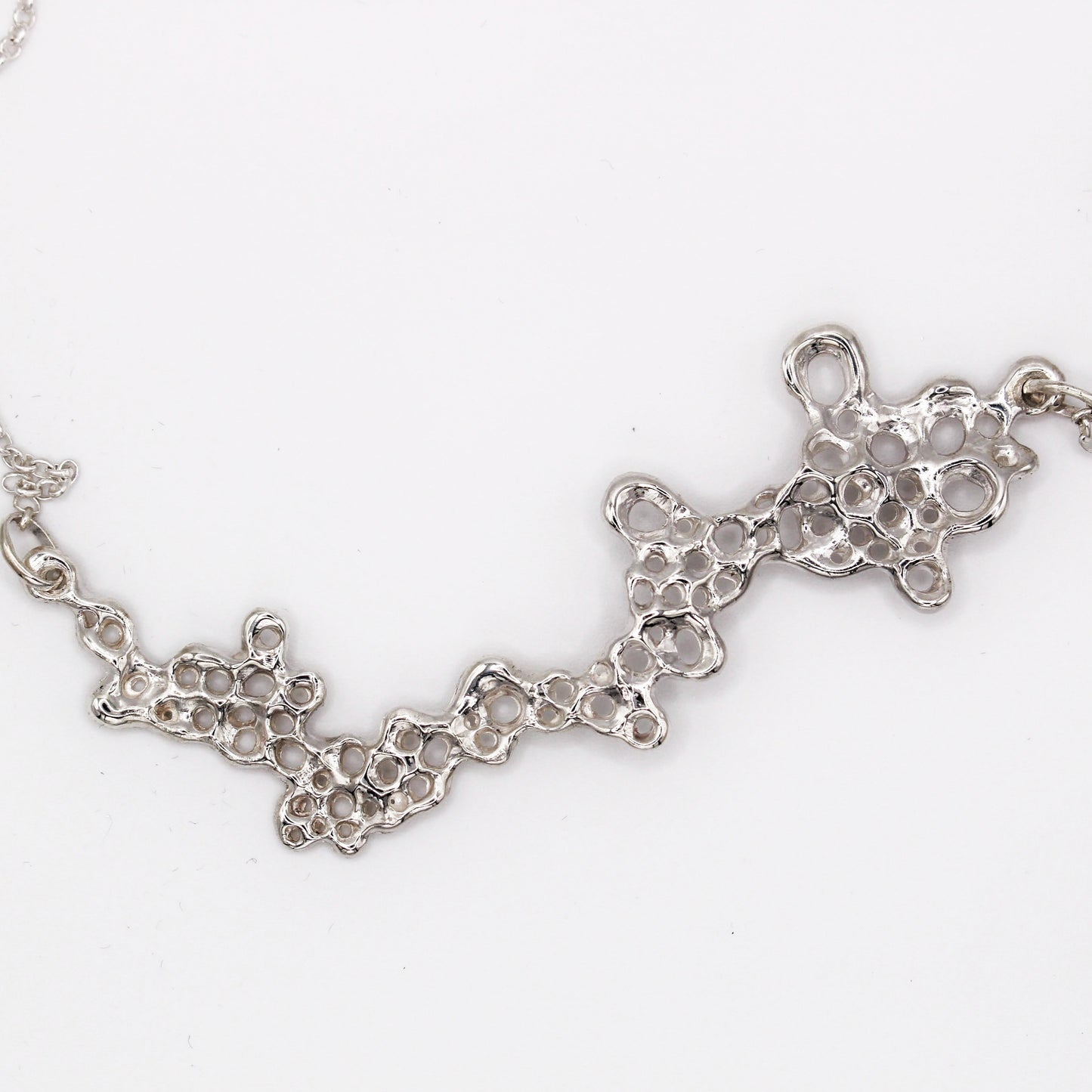 Raíz statement necklace handcrafted in sterling silver 925. Mediterranean-inspired jewelry featuring a large ocean-inspired pendant with sculptural, organic forms. A bold yet elegant sustainable piece, crafted for nature and contemporary jewelry lovers by Naturalesa.