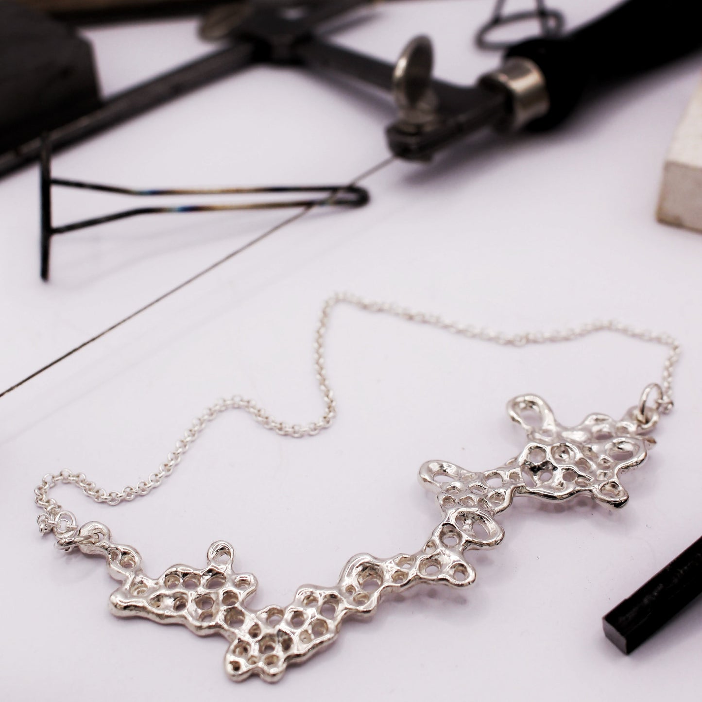 Raíz statement necklace handcrafted in sterling silver 925. Mediterranean-inspired jewelry featuring a large ocean-inspired pendant with sculptural, organic forms. A bold yet elegant sustainable piece, crafted for nature and contemporary jewelry lovers by Naturalesa.