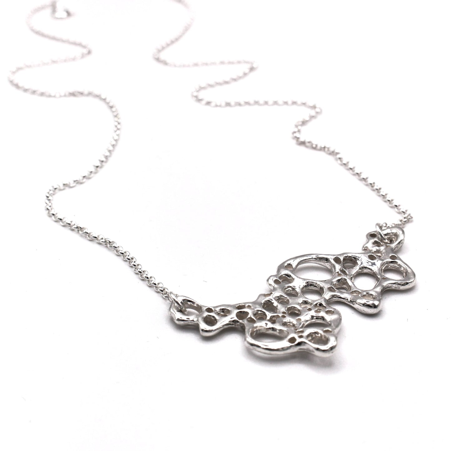 Silver necklace with a detailed pendant on a white background. Organic silver pendant necklace inspired by Mediterranean seafoam, meaningful artisan jewelry