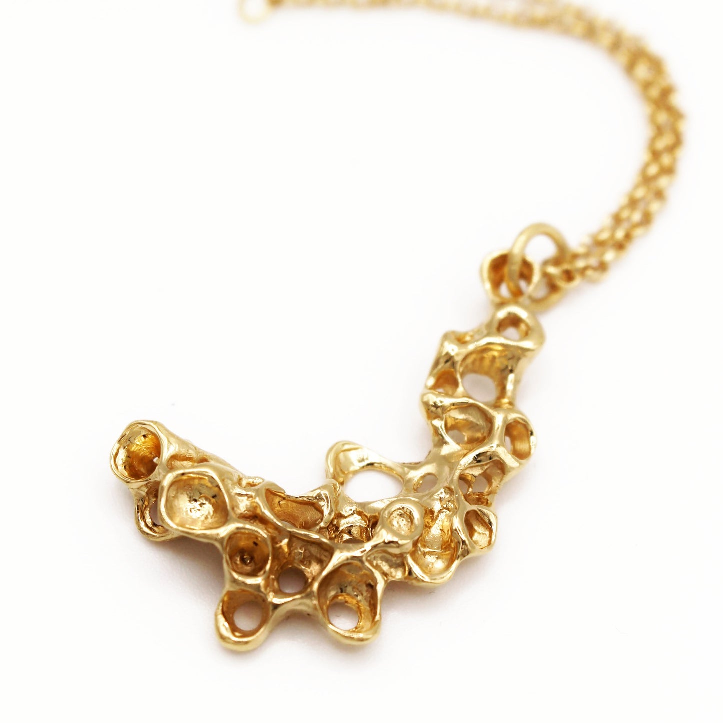 Sea inspired gold necklace with organic barnacle design, artisan symbolic jewelry