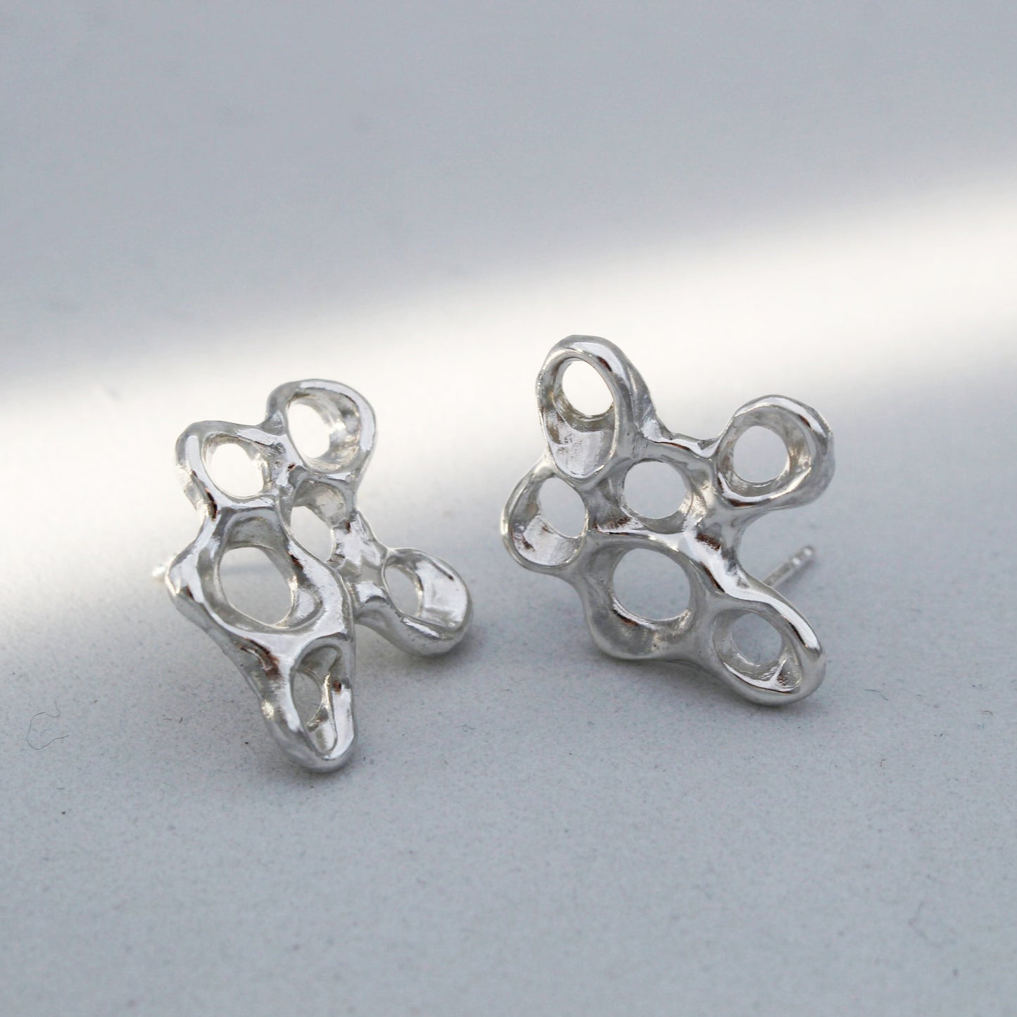 Silver barnacle earrings symbolizing resilience, artisan statement jewelry