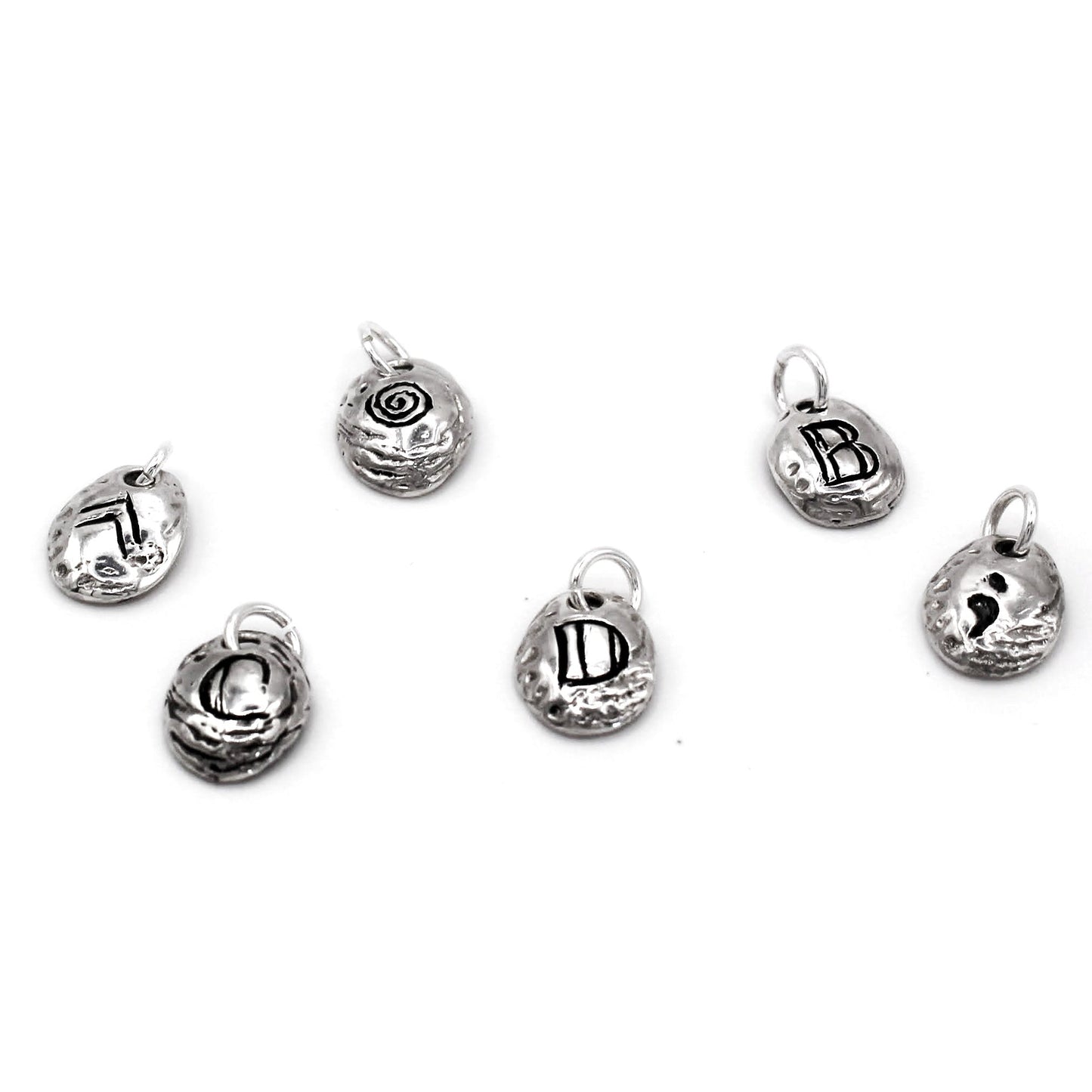 A collection of silver letter charms on a white background, with each charm engraved with a different letter of the alphabet.