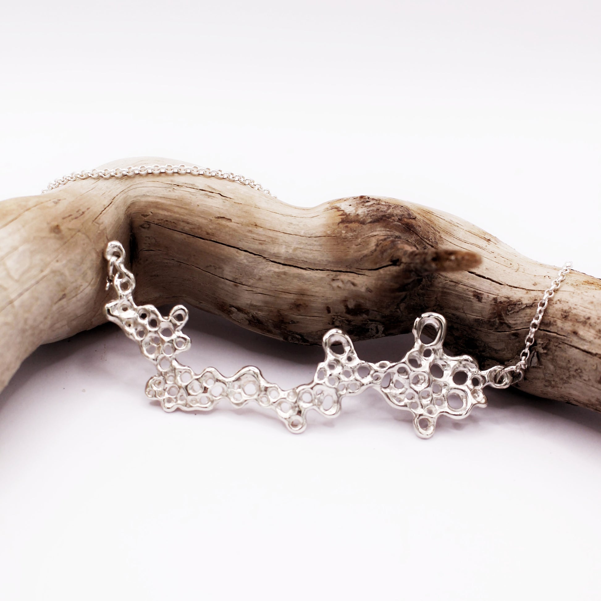 Raíz statement necklace handcrafted in sterling silver 925. Mediterranean-inspired jewelry featuring a large ocean-inspired pendant with sculptural, organic forms. A bold yet elegant sustainable piece, crafted for nature and contemporary jewelry lovers by Naturalesa.