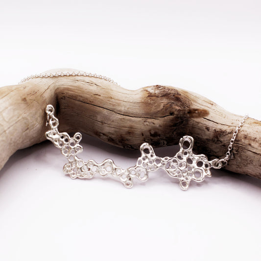 Raíz statement necklace handcrafted in sterling silver 925. Mediterranean-inspired jewelry featuring a large ocean-inspired pendant with sculptural, organic forms. A bold yet elegant sustainable piece, crafted for nature and contemporary jewelry lovers by Naturalesa.