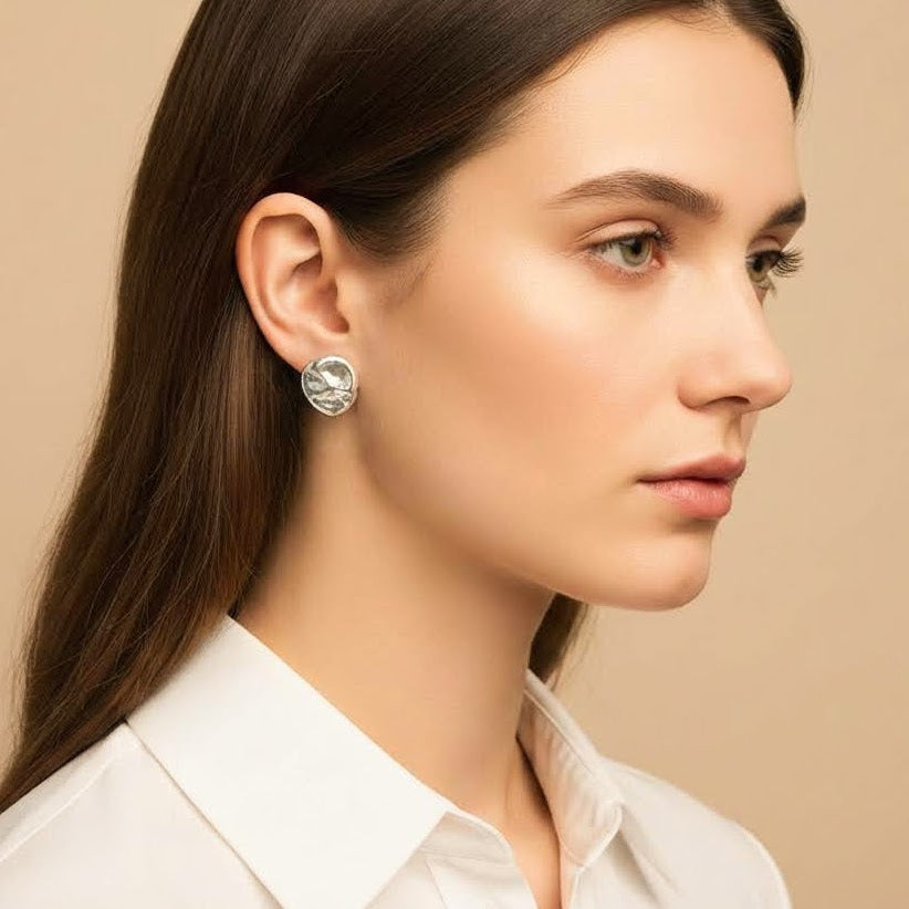 Organic sterling silver stud earrings worn on ear minimalist Mediterranean jewelry handmade in Spain