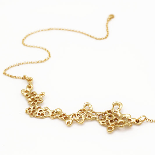 Raíz statement necklace handcrafted in sterling silver with a gold-plated finish. Mediterranean-inspired jewelry featuring a large ocean-inspired pendant with sculptural, organic forms. A bold yet elegant sustainable piece, crafted for nature and contemporary jewelry lovers by Naturalesa.