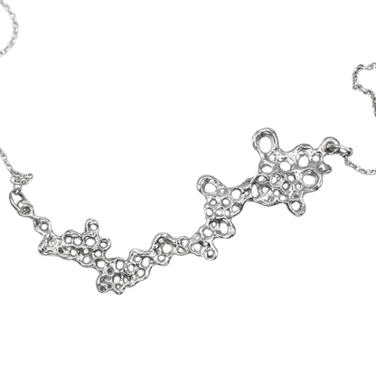 Raíz statement necklace handcrafted in sterling silver 925. Mediterranean-inspired jewelry featuring a large ocean-inspired pendant with sculptural, organic forms. A bold yet elegant sustainable piece, crafted for nature and contemporary jewelry lovers by Naturalesa.