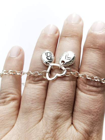 Personalized silver bracelet with heart clasp and engraved charms, meaningful jewelry gift for her on hand