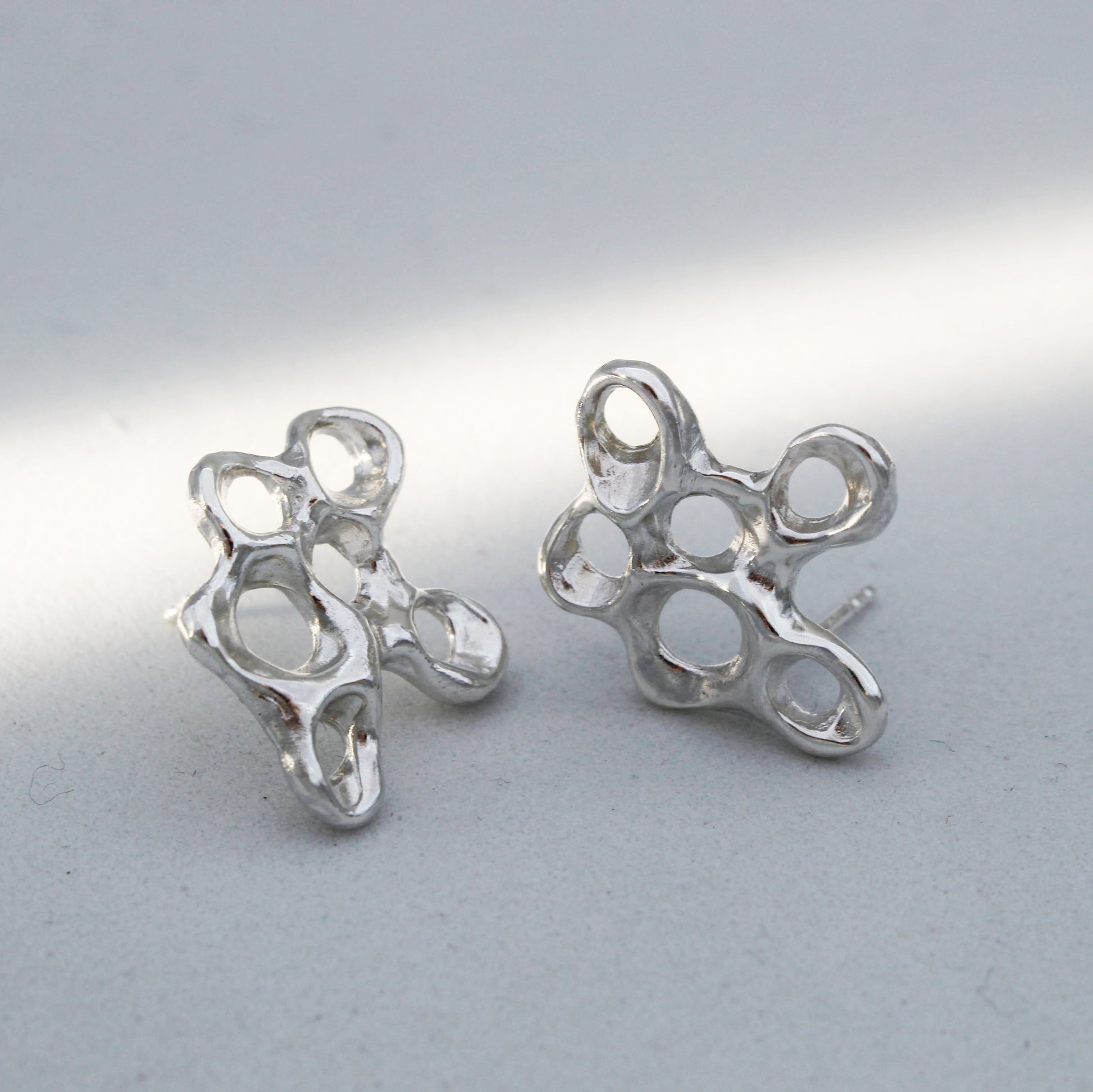 Silver barnacle earrings symbolizing resilience, artisan statement jewelry