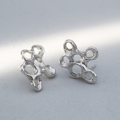 Silver barnacle earrings symbolizing resilience, artisan statement jewelry